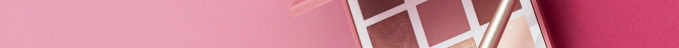 Eyeshadow palette with makeup brush on pink background, professional makeup tools