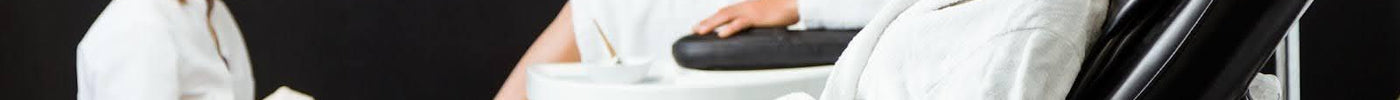 Modern beauty salon with comfortable pedicure chairs and clients receiving spa treatments